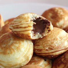 some cookies are stacked on top of each other in a white plate with chocolate inside