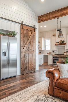 Spacious barndominium living area with vintage accents, reclaimed wood flooring, and industrial pendant lights