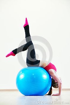 a woman is doing exercises on an exercise ball with her legs bent over her head