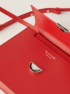 DESCRIPTION A reimagining of our exquisite Hye handbag. The Mini Hye in Red Leather effortlessly commands attention wherever you go. Crafted with precision, its angular lines gracefully define the bag's profile, adorned by our iconic OD lock in silver tone. Intricately crafted and endlessly elegant, Mini Hye can effortlessly transition from a shoulder bag to a crossbody, becoming an adaptable companion for every moment. Details Colour: Red Hardware: Signature OD push lock in silver finish Materi Leather Store, Polish Silver, South Korean, Lambskin Leather, Bag Making, Red Leather, Mini Bag, Leather Shoulder Bag, Calf Skin