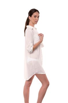 The Lydia is a button-up cover-up that can double as a shirt for a casual look. The off-white fabric has a light texture, and it is breathable and comfortable. The long sleeves can be folded and secured with a button on the side. One size. one size shoulder to bottom length: 35" (89cm) sleeves length: 21" (54cm) 100% Rayon (Viscose) Chic White Blouse With Roll-up Sleeves, White Button Closure Shirt Dress For Beach, Summer Blouse With Roll-up Sleeves And Shirttail Hem, Chic Long Sleeve Beach Shirt, Chic Long Sleeve Shirt For Beach, White Button-up Summer Blouse, White Shirt With Rolled Sleeves For Daywear, White Shirt With Rolled Sleeves And Spread Collar, Casual White Top With Roll-up Sleeves