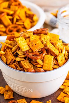 two bowls filled with cheetos sitting next to each other on a wooden table