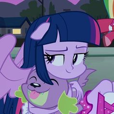 the pony is hugging another pony with its eyes closed