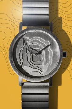 a watch that is sitting on top of a yellow background with an animal's face