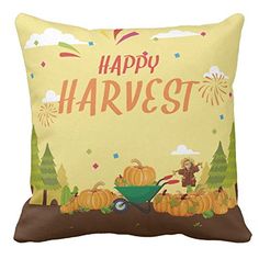 a happy harvest pillow with pumpkins and a wheelbarrow in the background on a yellow background