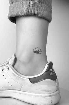 a woman's foot with a small tattoo on her left ankle and the word stay