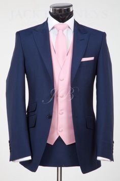 a mannequin wearing a blue suit and pink tie