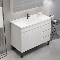 a bathroom with a sink, mirror and towel rack