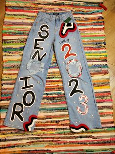 a pair of jeans that have been decorated with letters and numbers