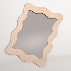 a mirror that is made out of wood and has an oval shape on the front