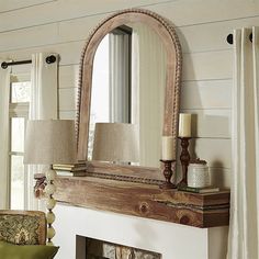 a mirror sitting on top of a mantle in a living room