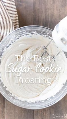 the best sugar cookie frosting recipe is in a glass bowl with a whisk