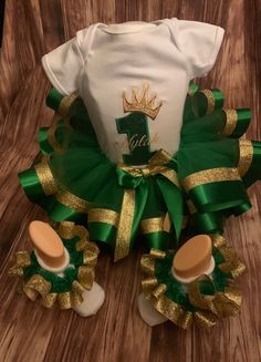 a green and gold diaper cake outfit with matching shoes for baby boys or girls