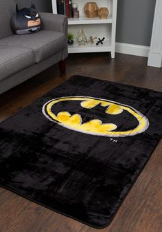 a batman rug in the middle of a living room