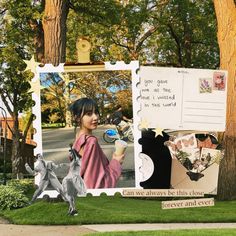 a collage of photos and postcards is displayed in front of a tree on the sidewalk