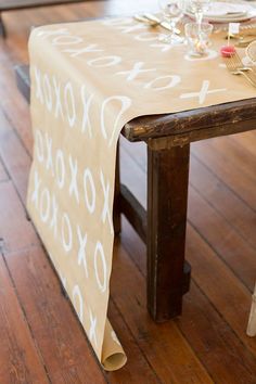 the table is set with gold place settings and napkins on it, along with silverware