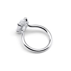 a white gold ring with an oval shaped diamond in the center, on a white background