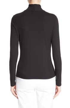 A sleek turtleneck crafted from smooth, lightweight stretch jersey is a wardrobe essential. 24" length (size Small) Slips on over head. Turtleneck. Long sleeves. 88% nylon, 12% spandex. Dry clean. By St. John Collection; imported. Collectors. Sleek Turtleneck Tops With Thumbholes, Classic Fitted Elastane Tops, Elegant High Stretch Tops With Thumbholes, Sleek Stretch Turtleneck Tops, Elegant Stretch Top With Funnel Neck, Elegant Funnel Neck Stretch Top, Elegant Stretch Funnel Neck Top, High Neck Elastane Turtleneck For Layering, High Neck Turtleneck For Layering