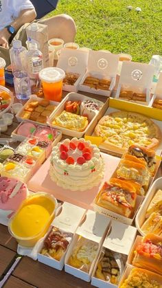 a table topped with lots of different types of cakes and desserts on trays