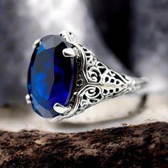 Discover timeless elegance with our Vintage 925 Solid Sterling Silver Royal Blue Simulated Sapphire Filigree Ring, an exquisite piece that captures the essence of classic beauty and sophistication. Meticulously crafted from high-quality 925 solid sterling silver, this ring showcases an intricate filigree design that exudes a sense of vintage charm. At its heart lies a stunning, large oval simulated royal blue sapphire stone, shimmering with a deep, mesmerizing hue that rivals the night sky. The ring is proudly stamped with "925," affirming its authenticity and sterling silver purity. Perfectly balanced in size and weight, this striking piece makes an ideal statement ring for any occasion--whether you're dressing up for a glamorous evening out or adding a touch of luxury to your everyday en Formal Oval Engraved Filigree Ring, Oval Sapphire Ring With Intricate Design, Engraved Oval Filigree Ring For Promise, Engraved Filigree Oval Promise Ring, Engraved Oval Filigree Promise Ring, Oval Engraved Sapphire Ring For Formal Occasions, Oval Sapphire Ring With Filigree For Formal Occasions, Formal Oval Sapphire Ring With Filigree, Engraved Oval Sapphire Promise Ring