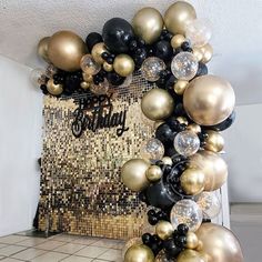 black, gold and white balloons are arranged in the shape of a frame