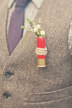 a boutonniere with flowers in it is tied to a suit