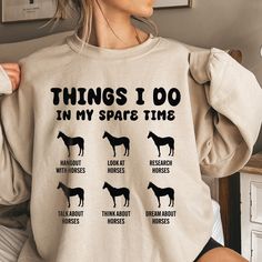 a woman wearing a sweatshirt that says things i do in my spare time with horses