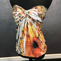 Orange And Yellow Abstract Floral Pattern. Size Large. Rue 21 Brand. Gently Worn. Very Soft And Silky Material. Shirt Has Padded Inserts In The Chest. This Item Is In Excellent Condition. You Might Mistake It For Brand New! Strapless Summer Party Tops, Chic Strapless Top With Floral Print, Chic Strapless Floral Print Top, Stretch Floral Print Top For Beach Season, Summer Floral Print Party Tops, Strapless Stretch Top For Vacation, Orange Floral Print Tops For Beach Season, Yellow Floral Print Party Blouse, Strapless Floral Print Top For Spring