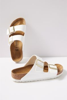 Clean white leather gives an eye-catching update to these iconic Birkenstock sandals, featuring an adjustable two-strap design and a comfy cork footbed. At the heart of every Birkenstock design is the legendary footbed. The details are all in the design; each element of the footbed serves a purpose to encourage proper foot health. The result is signature style coupled with all-day comfort. White Slides With Cork-bed Midsoles For Spring, White Double Strap Sandals With Cork-bed Midsoles, Summer Double Strap Sandals With Branded Heel, White Slides With Buckle Closure For Spring, White Flat Leather Footbed Sandals, White Leather Footbed Sandals With Double Strap, White Leather Footbed Open Toe Sandals, White Closed Toe Leather Footbed Sandals, White Closed Toe Footbed Sandals With Buckle Closure