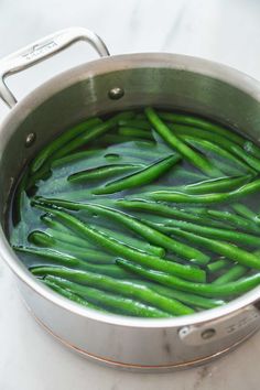 green beans are being cooked in a pot