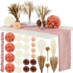 an assortment of dried flowers are displayed on a white table with pink and orange accents