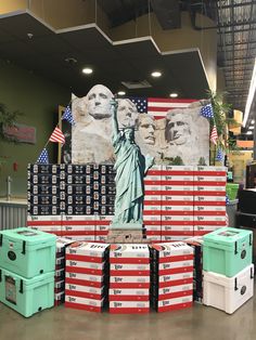 the statue of liberty is surrounded by many coolers and boxes in front of it