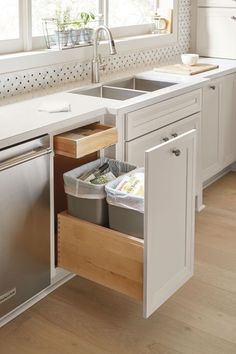 an open drawer in the middle of a kitchen