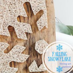 the string art snowflake is displayed on a wooden board with text overlay that reads falling snowflake string art patterns