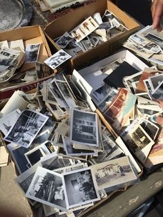 an open box filled with old black and white photos