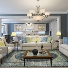 a living room filled with furniture and a chandelier