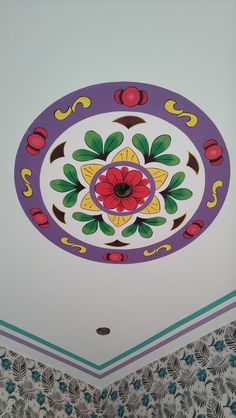 the ceiling is decorated with colorful flowers and swirls in purple, green, yellow and red