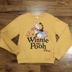 New With Tags This Womens Disney Winnie The Pooh Character Print Sweatshirt Is A Size Extra Small. It Is Golden Brown In Color With A Large Character Print On The Front. There Is Elastic At The Neck, Sleeves, And Waist. Made Of 60% Cotton And 40% Polyester. Measurements Are 25 Inches From Shoulder To Bottom, 19 Inches Armpit To Armpit, And 24 Inch Sleeves. Disney Letter Print Top For Fall, Disney Character Print Tops For Fall, Fall Disney Character Print Tops, Disney Long Sleeve Relaxed Fit Top, Disney Style Long Sleeve Tops With Relaxed Fit, Disney Tops With Relaxed Fit And Long Sleeve, Pooh And Piglet Quotes, Piglet Quotes, Winnie The Pooh Character