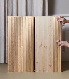 a person is opening the door to another piece of wood that has been made from plywood