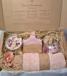 an open box containing soaps, body lotion and handmade items in it