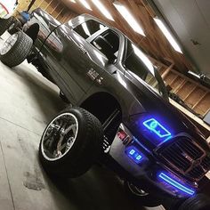 the truck is parked in the garage with its lights on