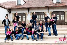 a group of people posing on steps in front of a building