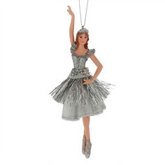 a christmas ornament with a woman in a silver dress