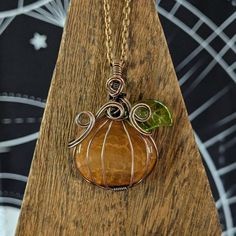 These pumpkin pendants are the perfect accessory for lovers of all things Fall! 🍂 Handcrafted with your choice of mookaite or fire agate, each stone is unique creating a one-of-a-kind piece. Please refer to listing details for jewelry attributes. ✦ Disclaimer ✦  Avoid contact with moisture, hair spray, colognes, etc. Made with either tarnish resistant silver plated copper wire or antiqued copper wire. Copper may leave a light mark on skin over time. Please note that this wire is soft & able to be bent if not handled carefully. All measurements are approximate. Sold as a curio. ★ Please follow The Finch & The Forest on social media! ★ Here you will find magick, mythology, & folklore intertwined with shop products as well as upcoming sales & giveaways! Follow below at - ★ www.thefinchandthe Wire Wrapped Crystal Pendant, Pumpkin Necklace, Fall October, Moisture Hair, Wire Wrapped Crystal, Wrapped Crystal, October Birthday, Witchy Jewelry, Wire Wrapping Crystals