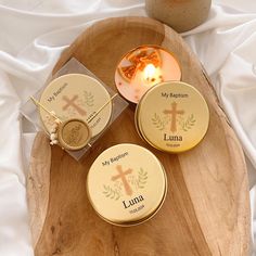 three personalized candles on a wooden tray with the names of jesus and luma