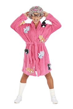 a woman in a pink bathrobe with cats on it