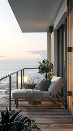 a balcony with a chair and table overlooking the ocean