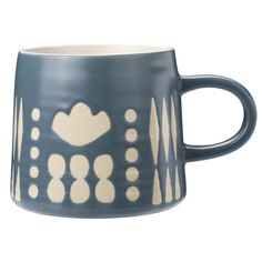 a blue and white coffee cup with dots on it