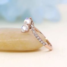 a diamond ring sitting on top of a rock