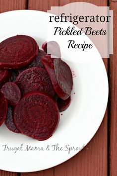 a white plate topped with sliced beets on top of a wooden table